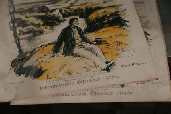 Farbig illustriertes Titelblatt mit einer ruhenden Figur in einer Landschaft, darunter „Johann André, Offenbach a/Main“
